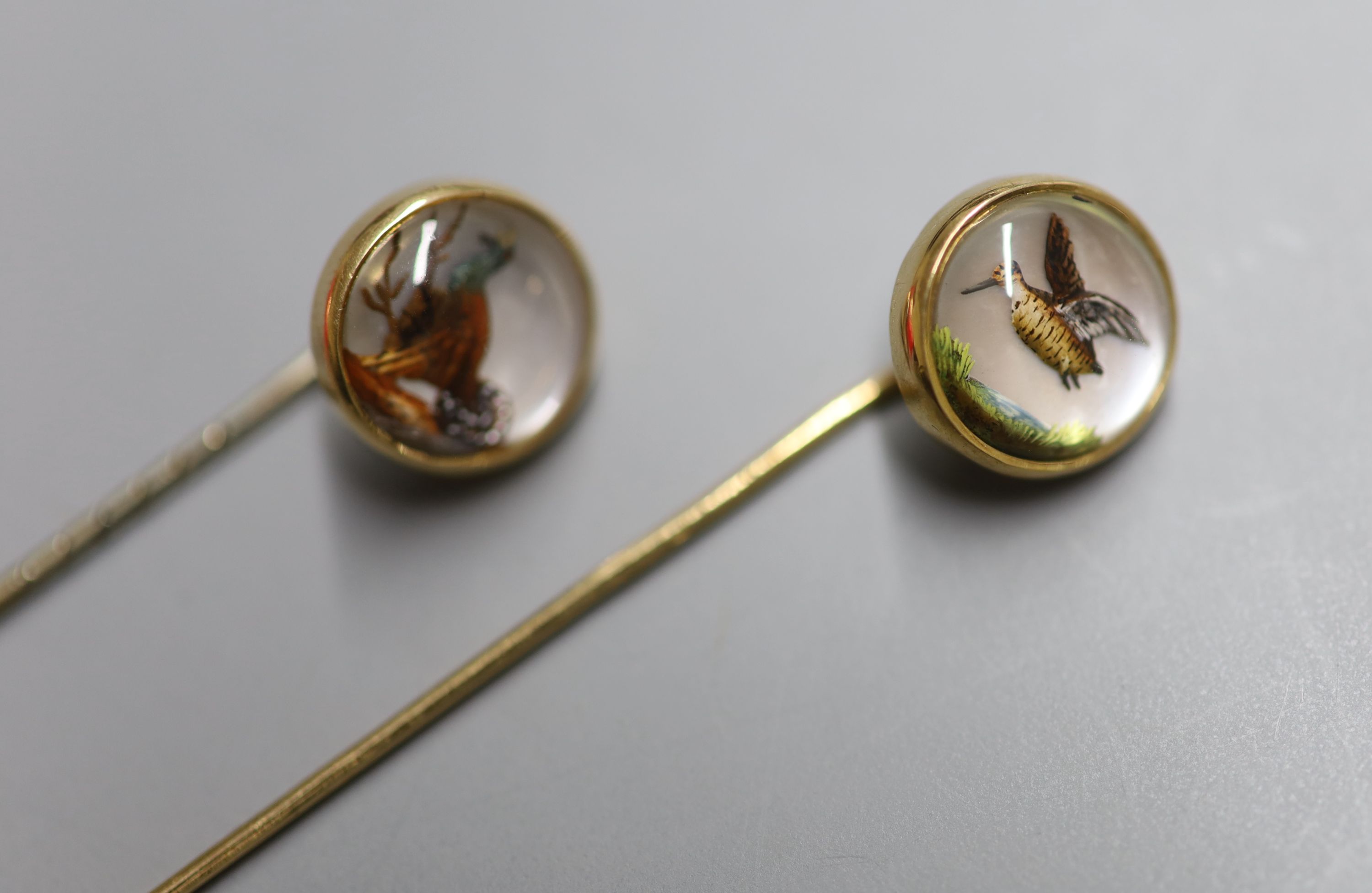 Two yellow metal and Essex crystal stick pins, decorated with game birds, largest 72mm, gross 5.8 grams.